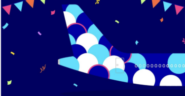a blue and white airplane tail with colorful circles and confetti